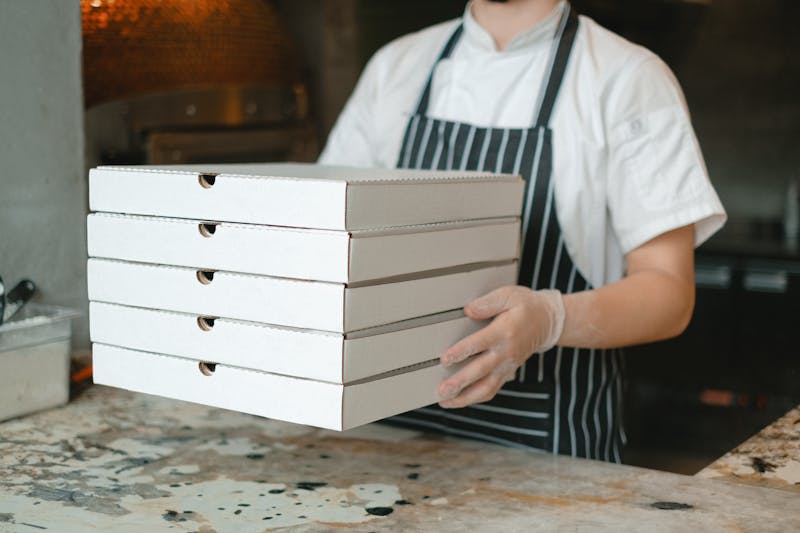 Pizza being boxed for delivery